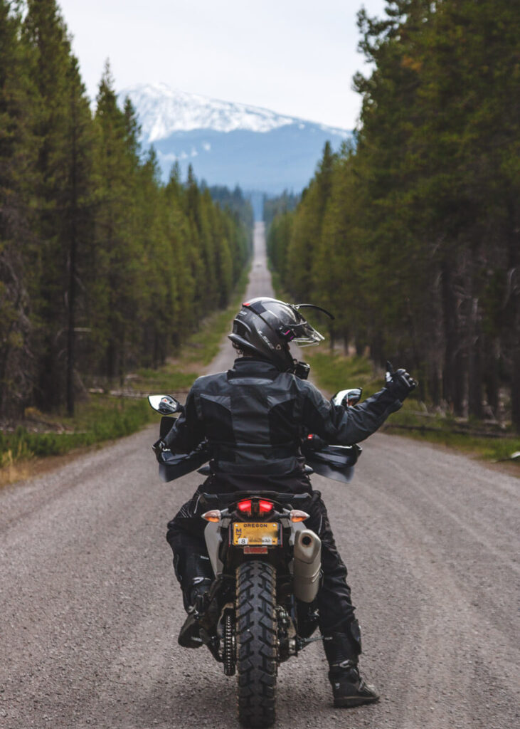 Me riding a long straight gravel road on the Oregon Backcountry Discovery Route. 