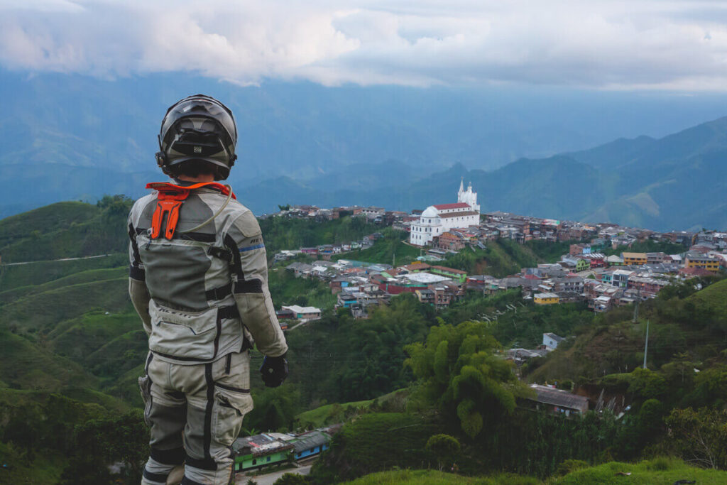 ADV rider sporting the Scorpion XO-AT950 modular motorcycle helmet while overlooking a valley in Colombia. 