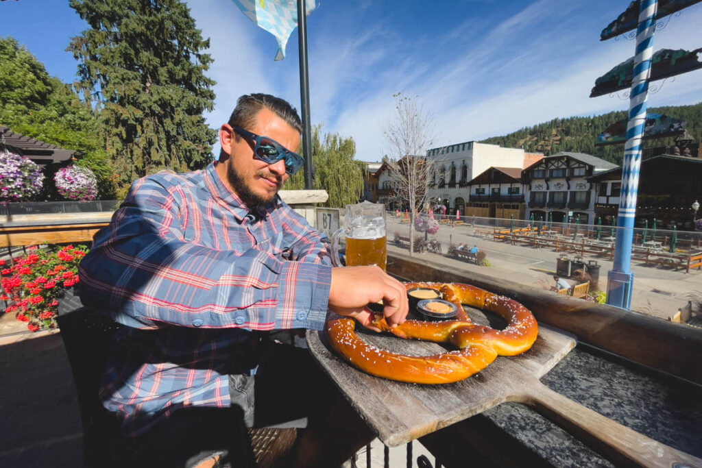 Eating a big pretzel and drinking a stein of hefe in Leavenworth, Washington.