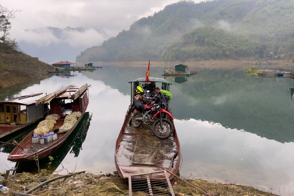 Loading Motorcycles on a Boat in Vietnam During a Wet Day.